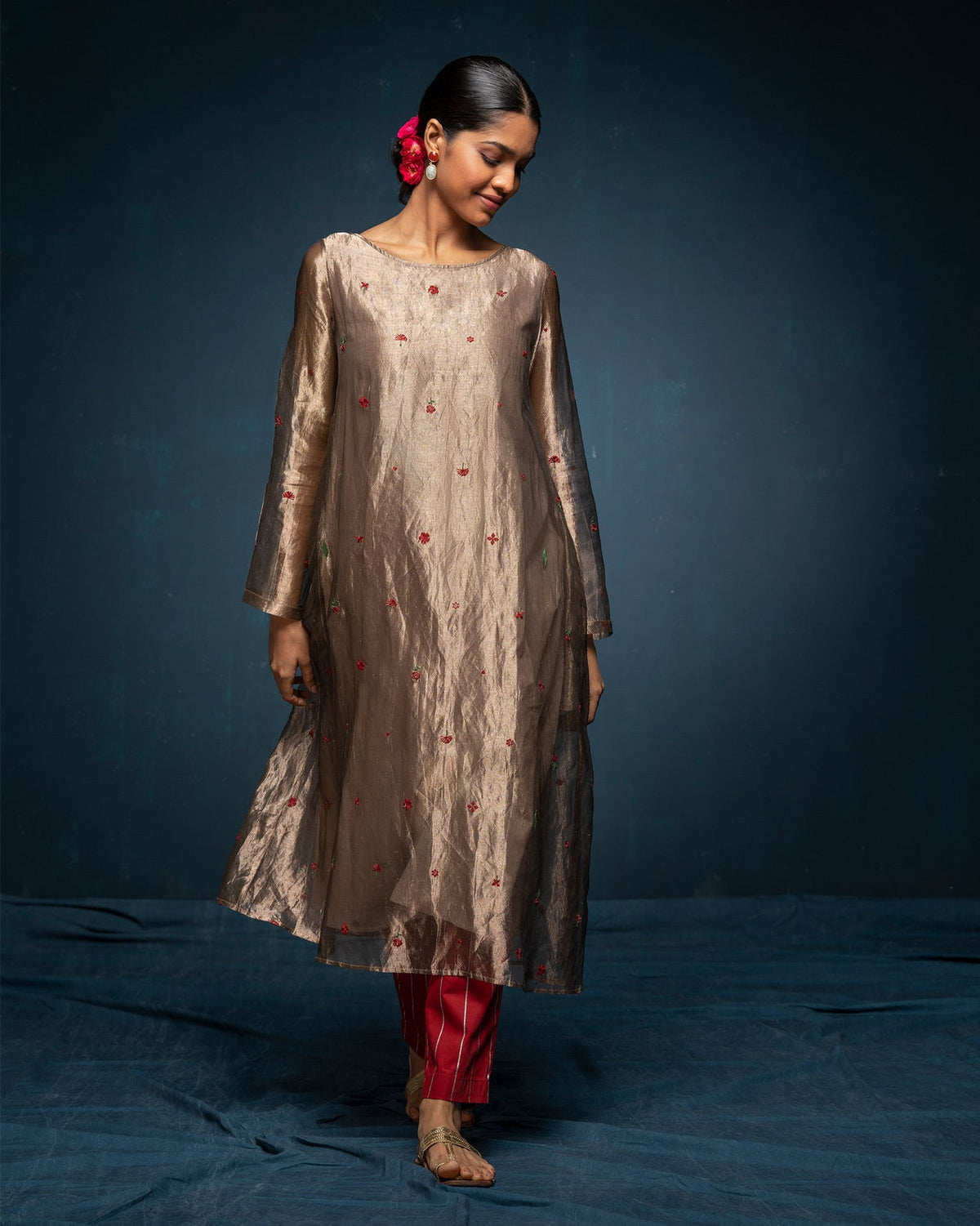 Person in a gold Boat Neck Kurta with a loose, flowing fit.