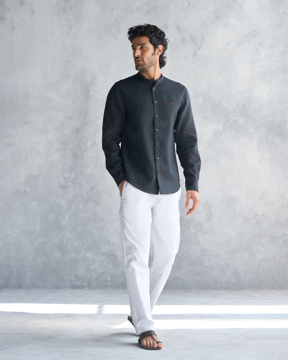 Person wearing a black Nawab Shirt with a band collar, shown full length.