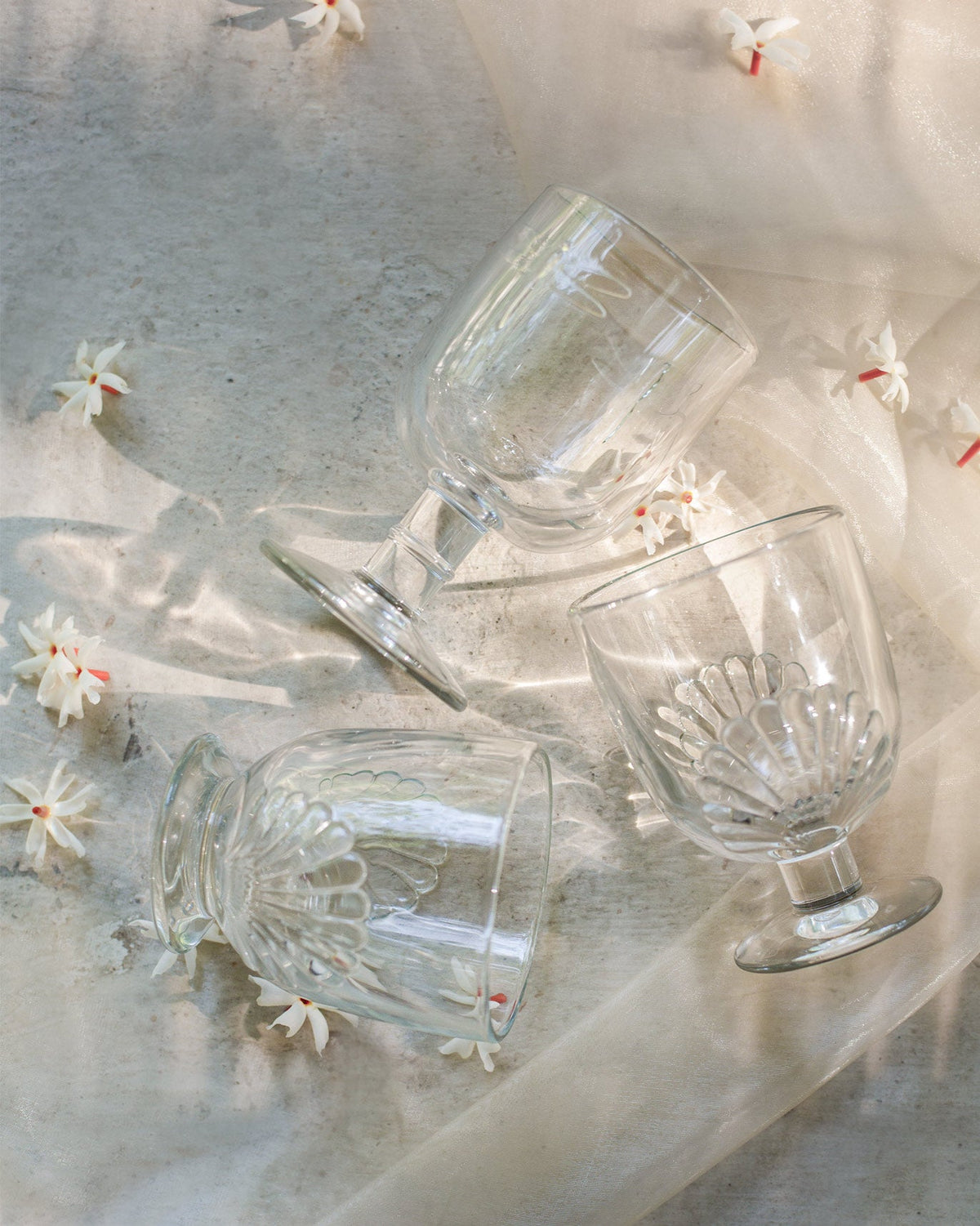 Mahi Goblets tipped on a light cloth, showing their scalloped bowls.