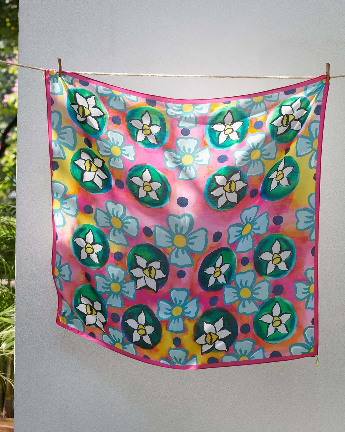 Meadow scarf hung flat, showing white flowers in green rings and blue blooms on pink.