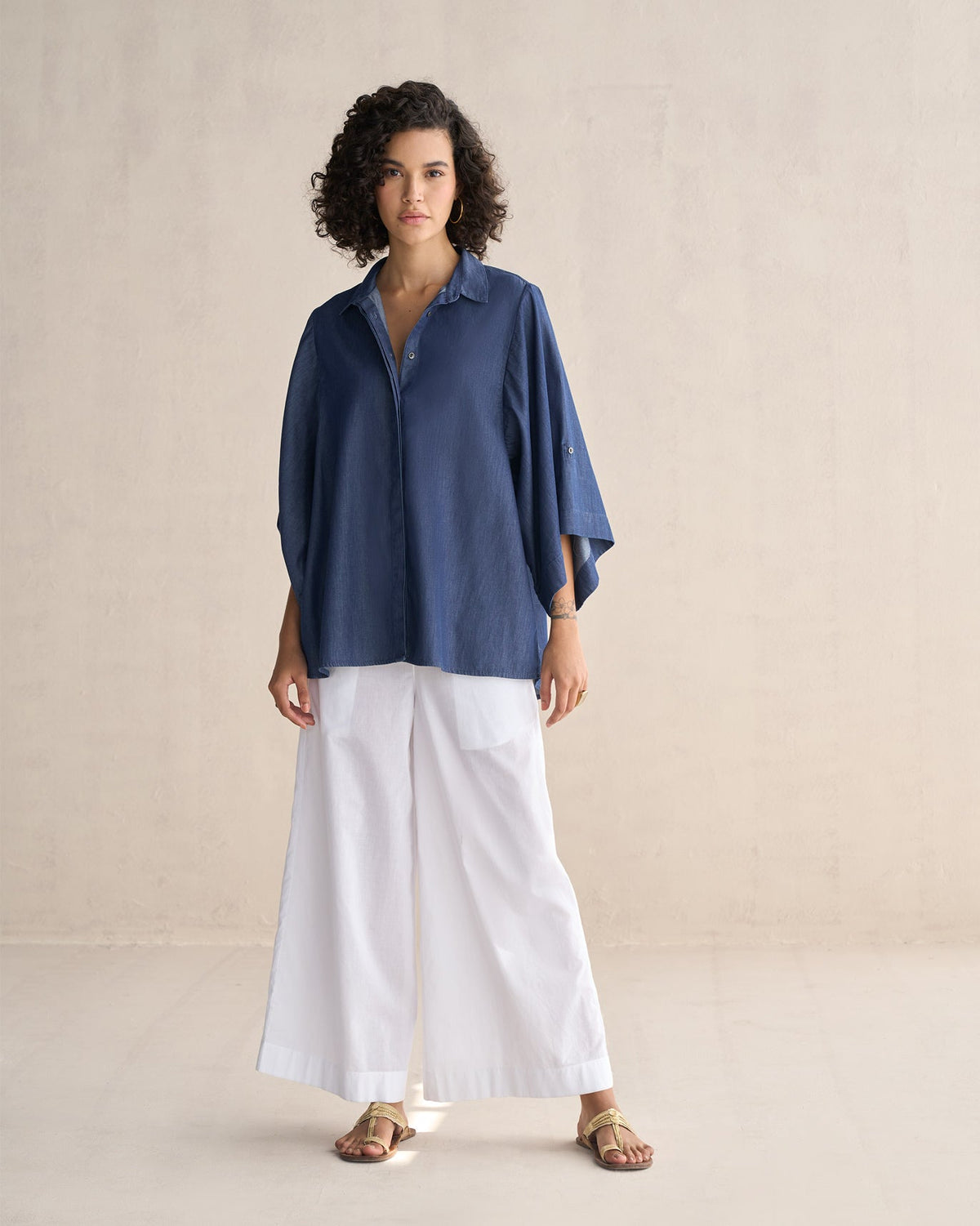 Full-length view of the Drop Armhole Shirt in blue, worn by a person.