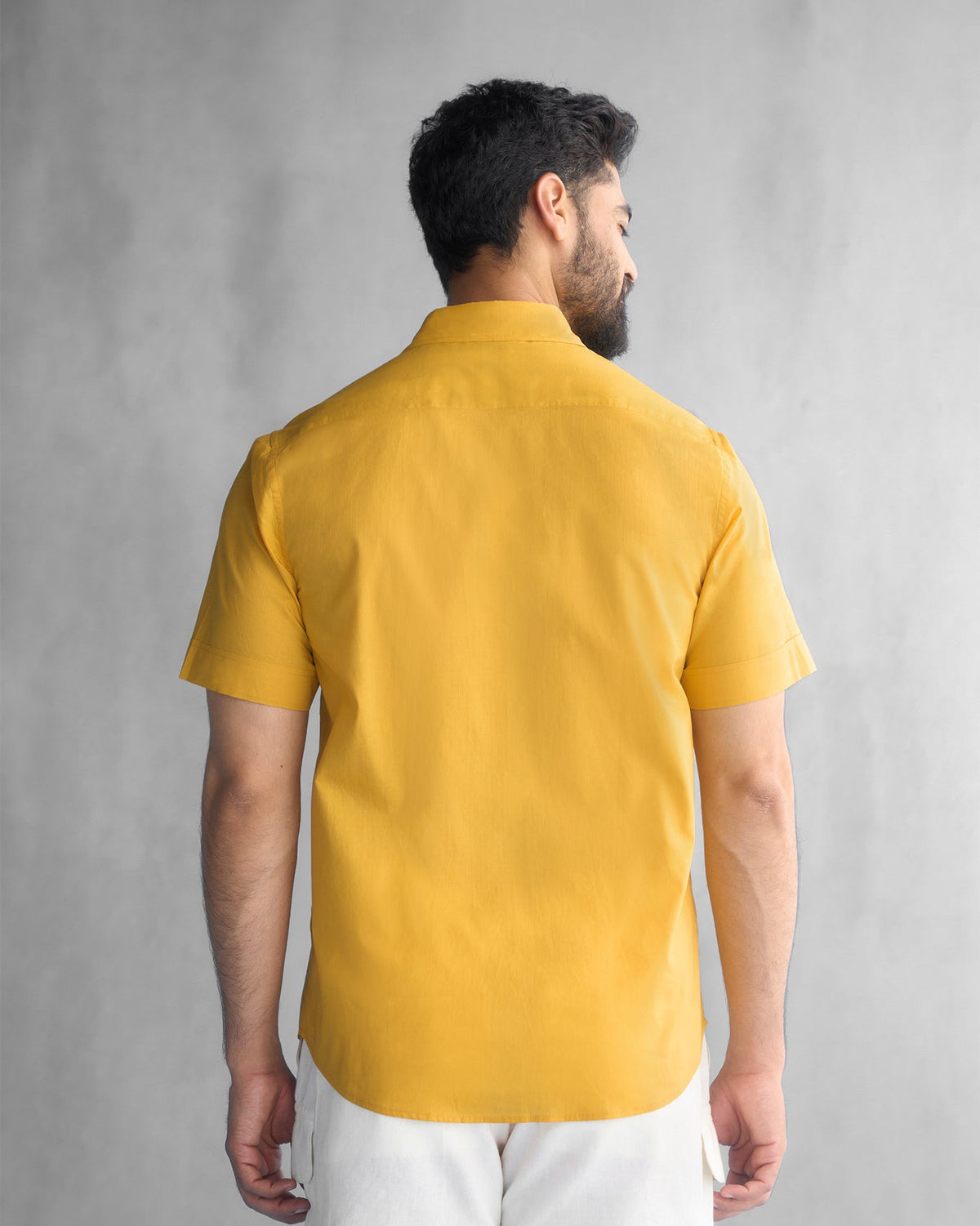 Back of an ochre Half Sleeve Shirt worn by a person.