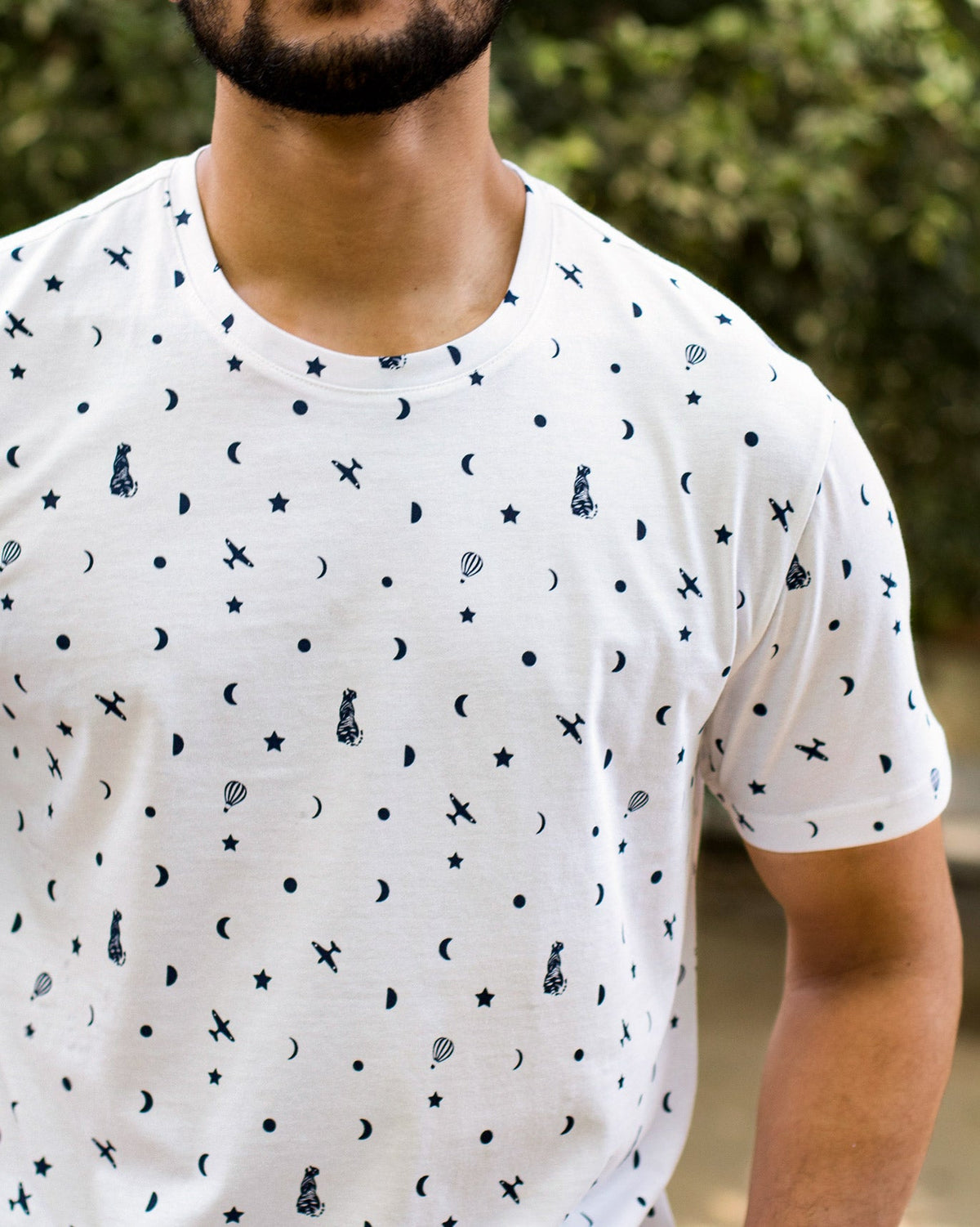 Close-up of the Up and Away T-Shirt print of planes, moons and stars.