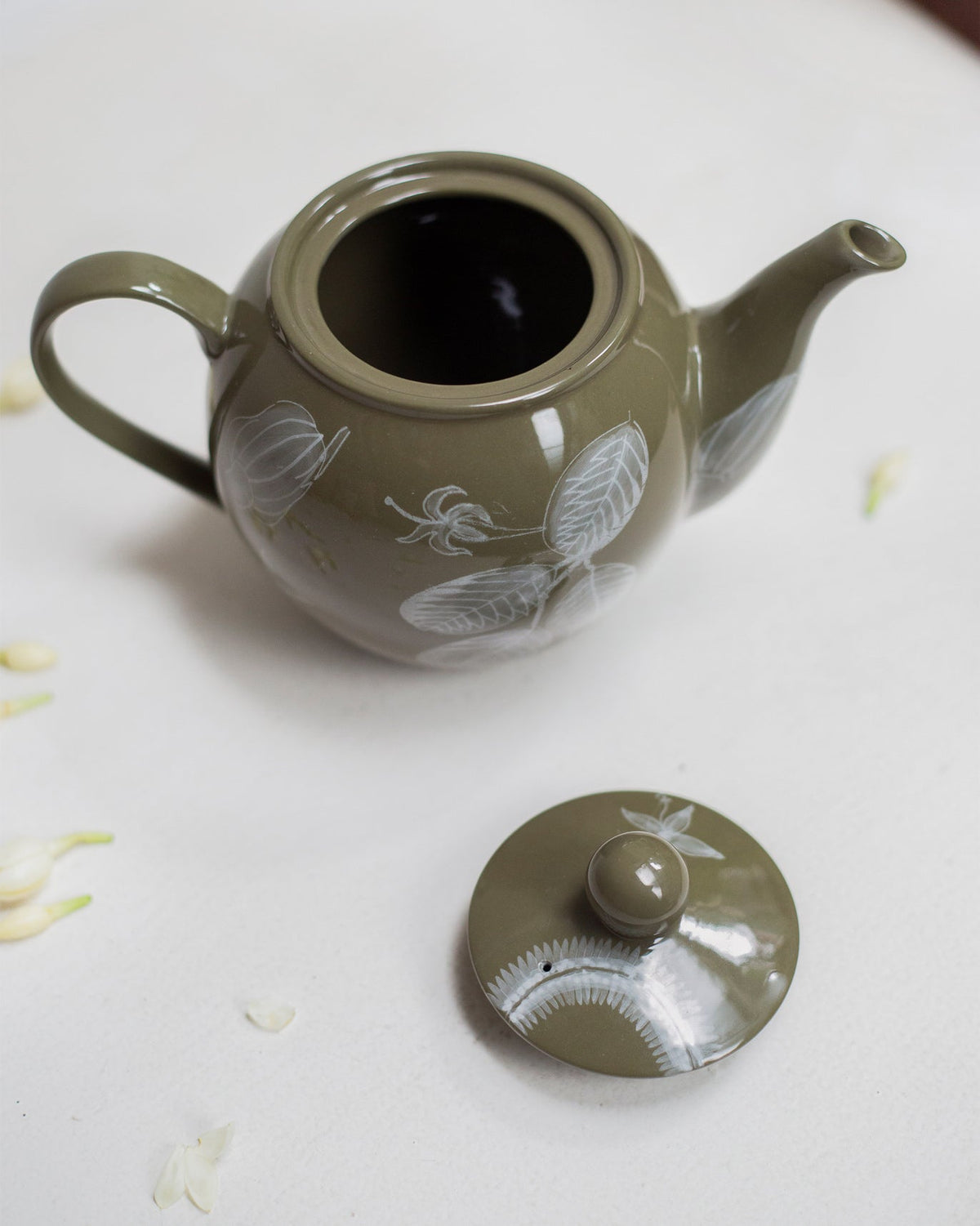 Mandovi Teapot with its lid off, showing the open pot and white leaf motifs.