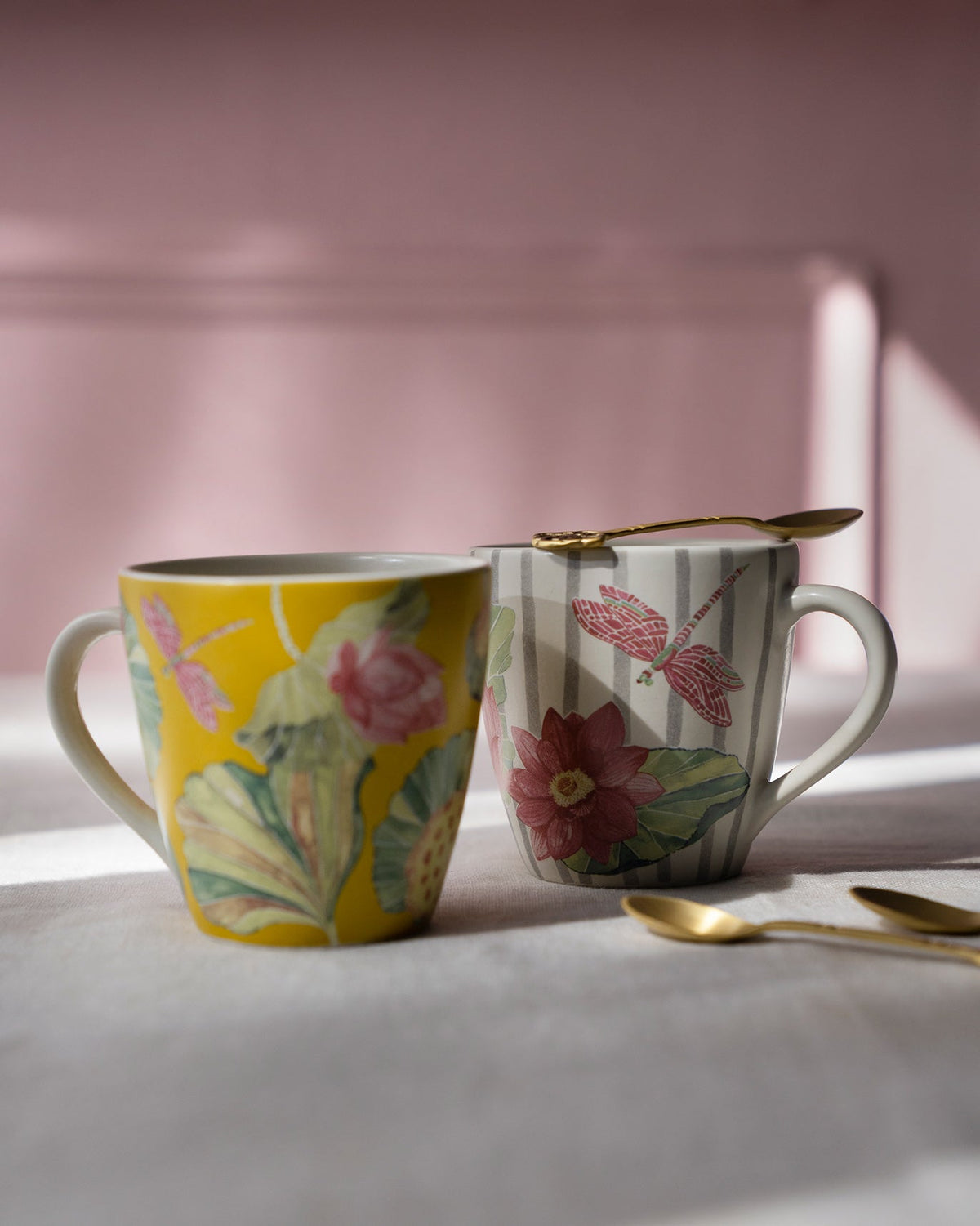 Yellow and striped Lotus Garden mugs with lotus and dragonfly motifs.