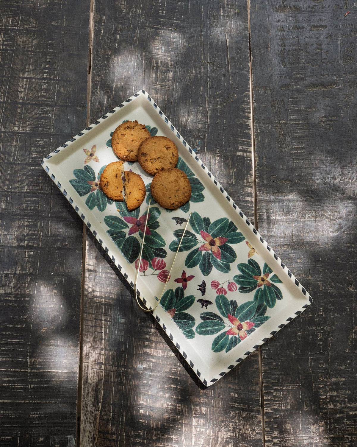 Flora Cookie Tray with Tong holding cookies on its floral print.