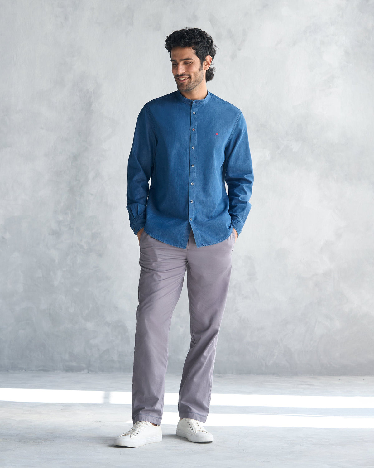 Person wearing a blue Nawab Shirt with a band collar, shown full length.