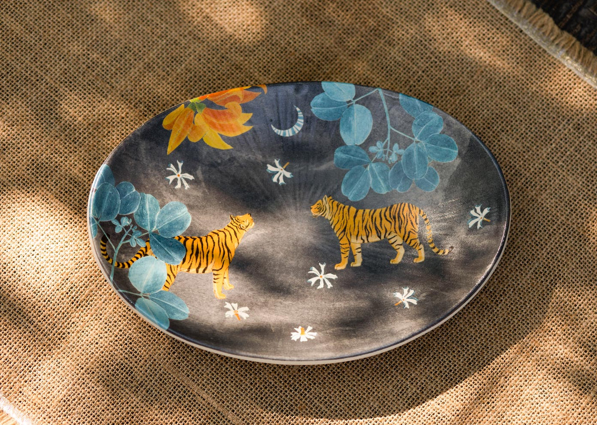 Overhead view of the Nadi Oval Platter with two tigers and white flowers.