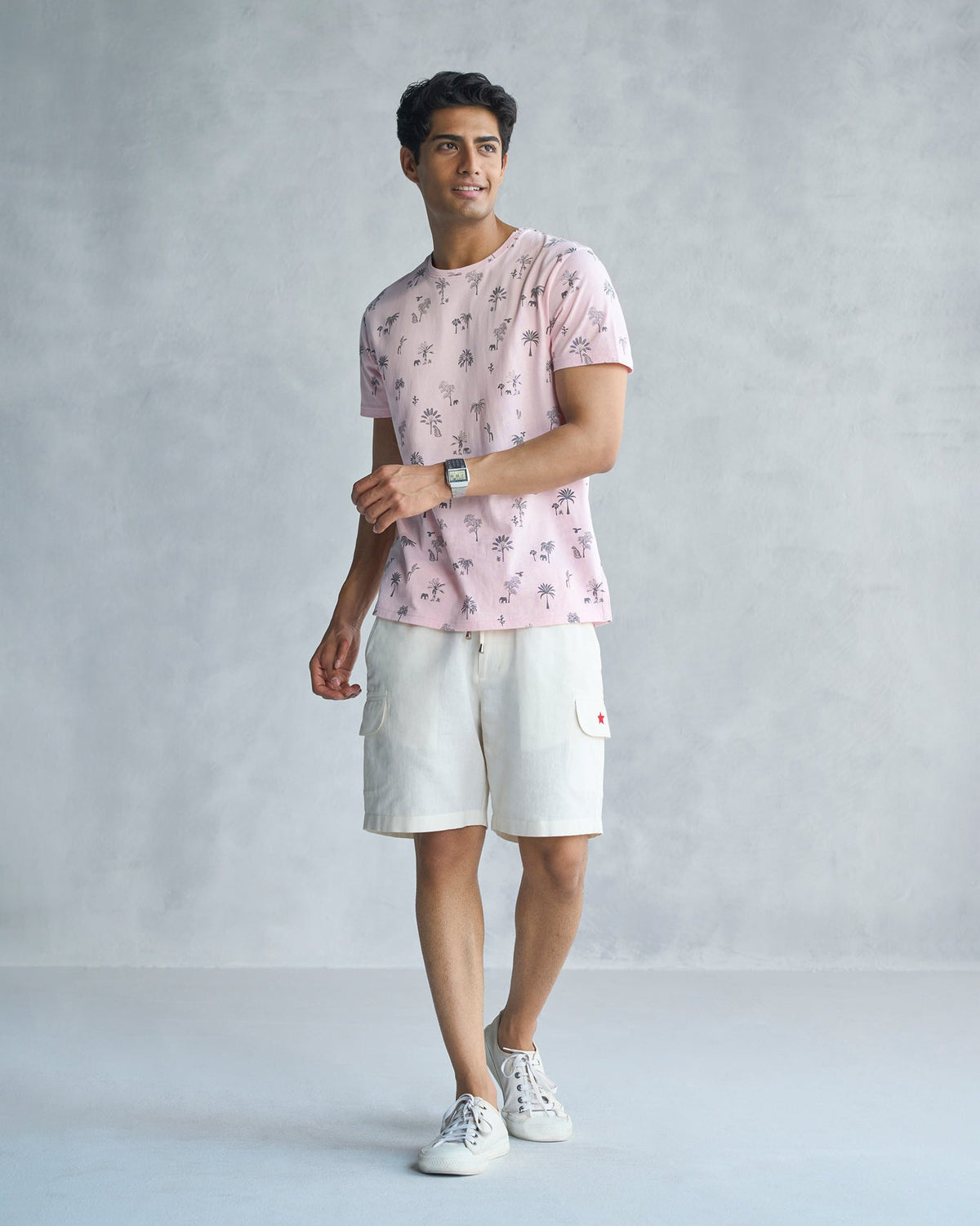 Full-length view of a soft pink Jungle T-shirt worn by a person.