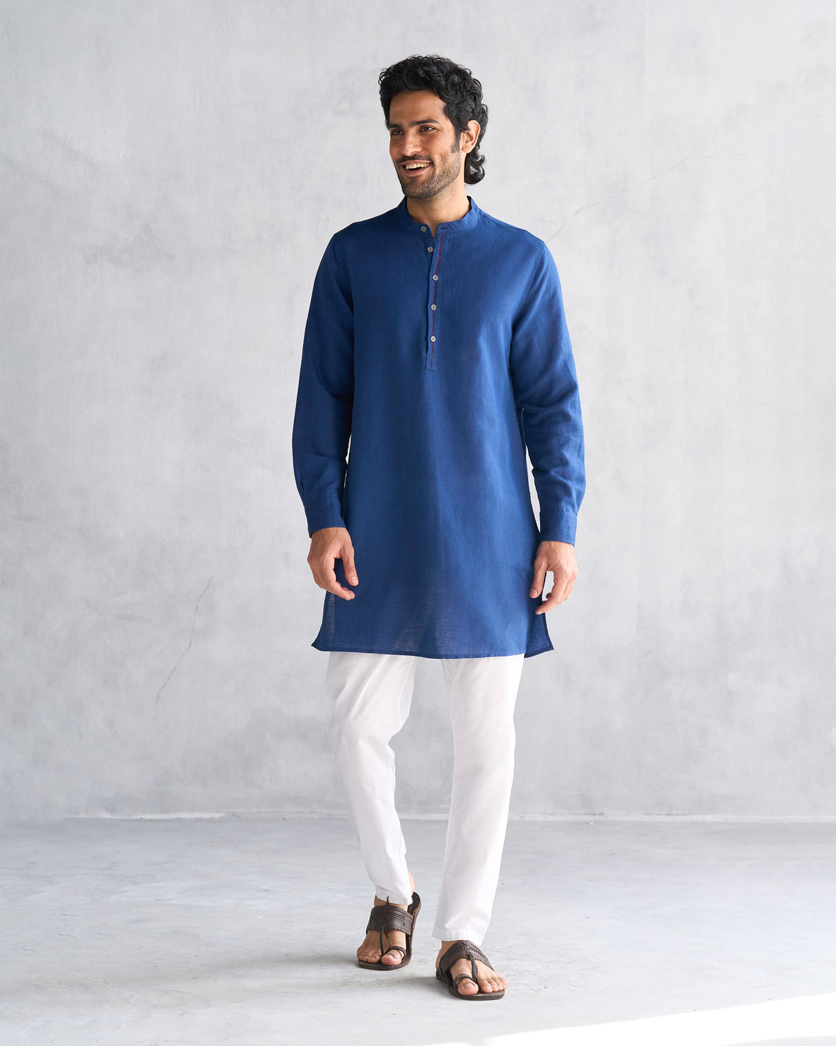 Person wearing a mid-thigh navy Chandni Chowk kurta.