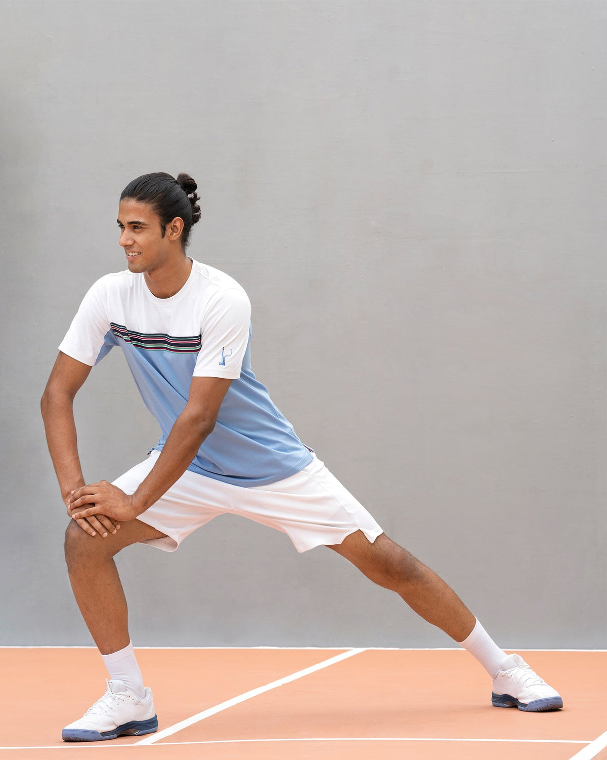 Person in an Everyday Crew Neck T-shirt with a striped chest band, in a lunge pose.