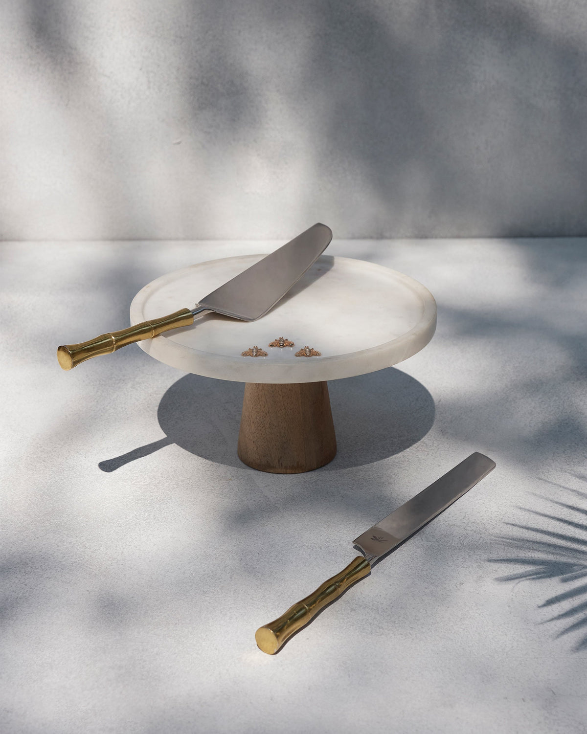 Firefly cake stand with a server and knife on a table.