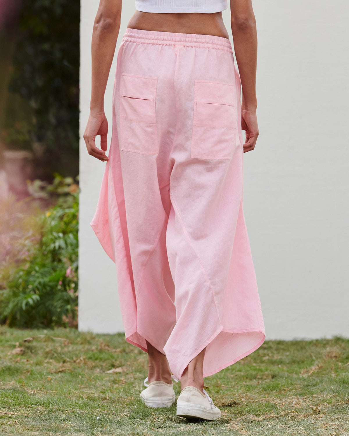Back of Yoka Trousers in pink worn by a person.