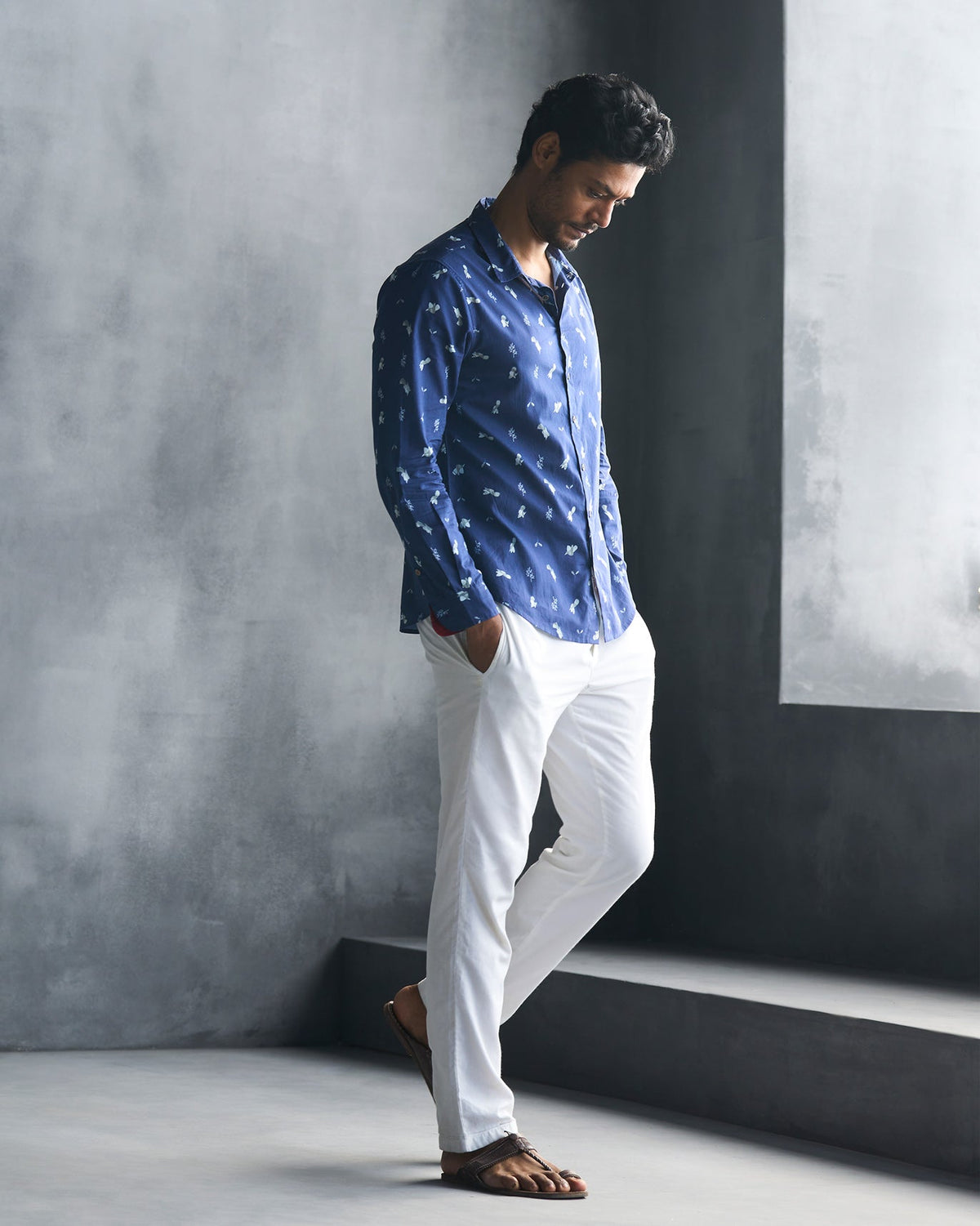 Side view of a navy Hakuna Shirt worn by a person.