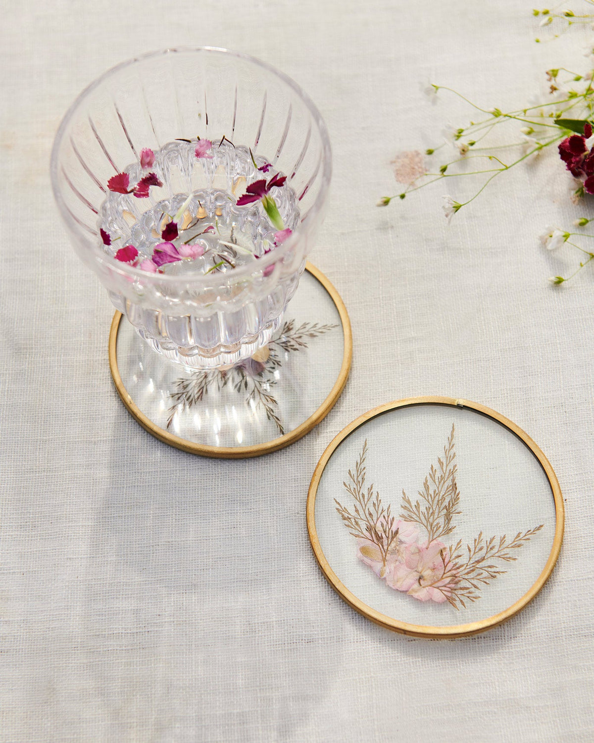 Waadi Coaster with pressed fern and flower detail beside another coaster.