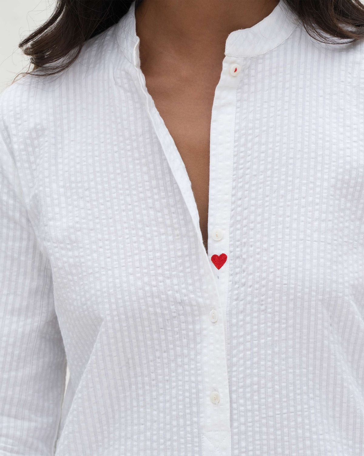 Close-up of a white Basic Long Length Kurta showing a red heart on the placket.