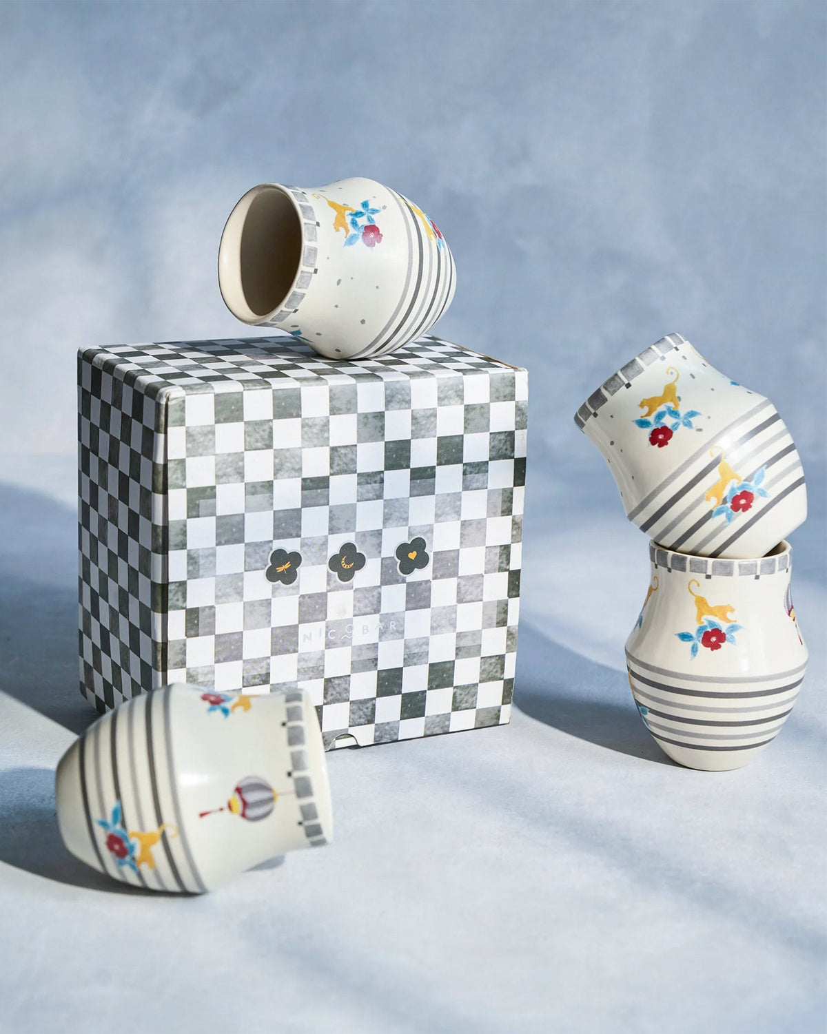 Phoenix kulhar cups around a checkered gift box.