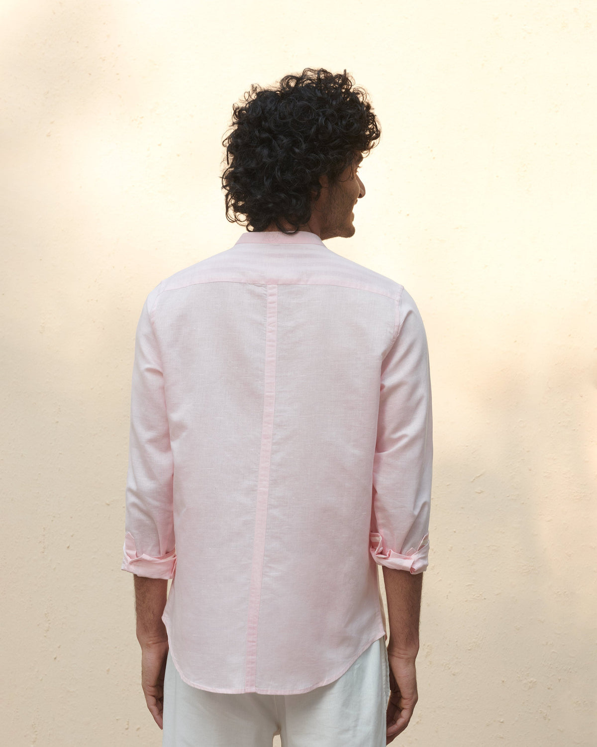 Back of a pink Nawab shirt worn by a person.