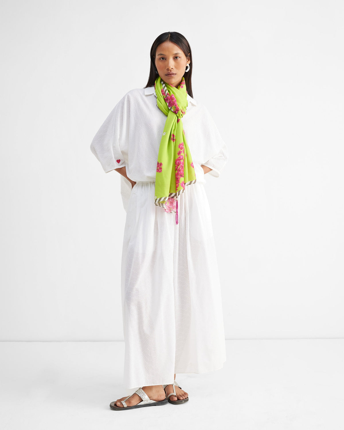 Full-length view of a person wearing white Yoi Hem Pants with an elastic waist.