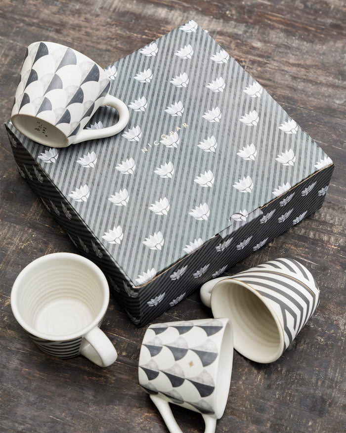 Set of four Khardung espresso mugs around a Nicobar gift box.