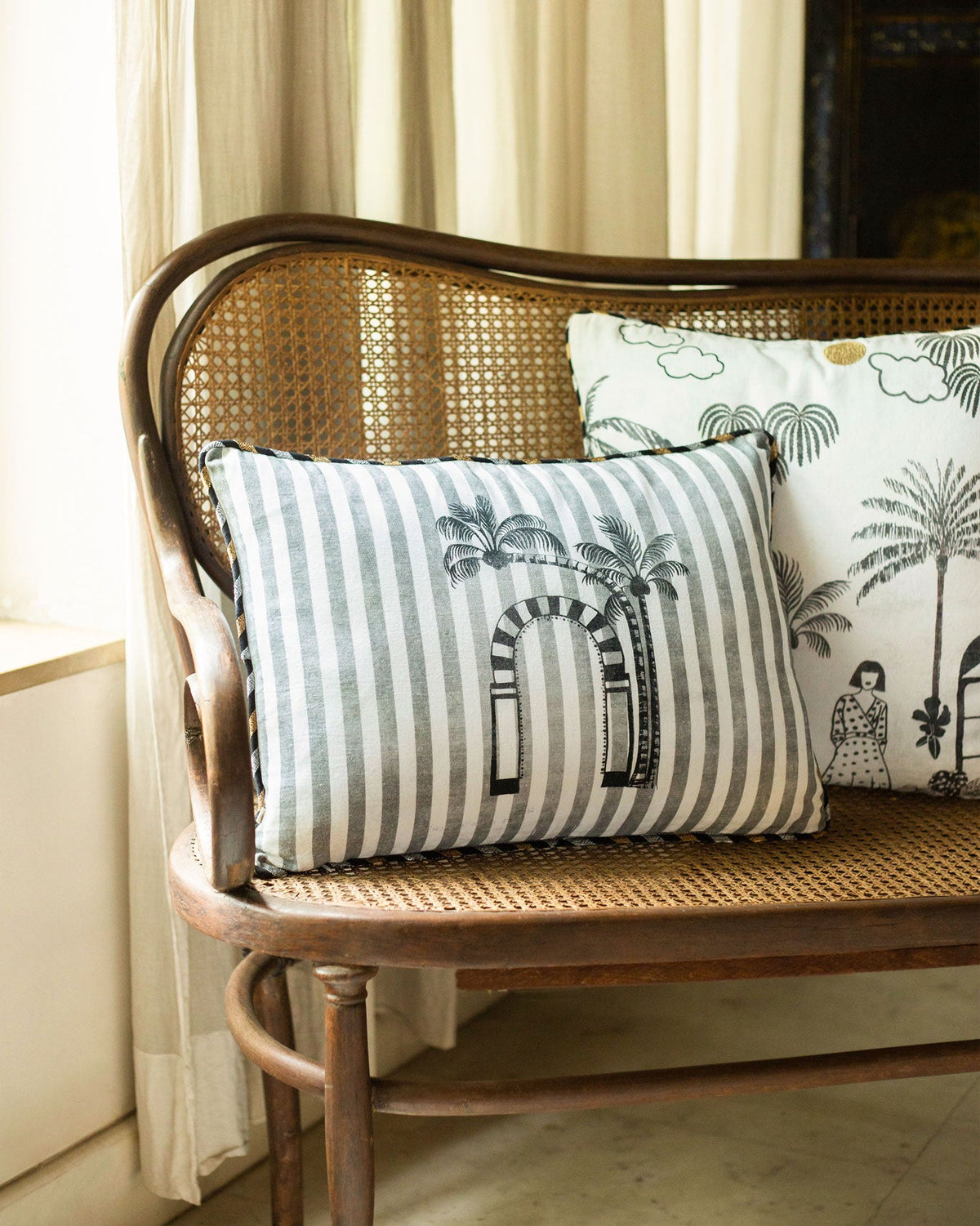 Coastal Evening Cushion Cover in grey and cream stripes with a palm arch motif.