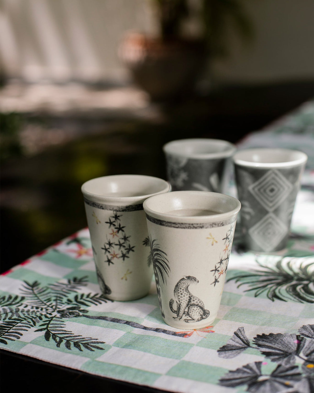 Periyar Kulhars with a leopard and star design, placed in front of other cups.