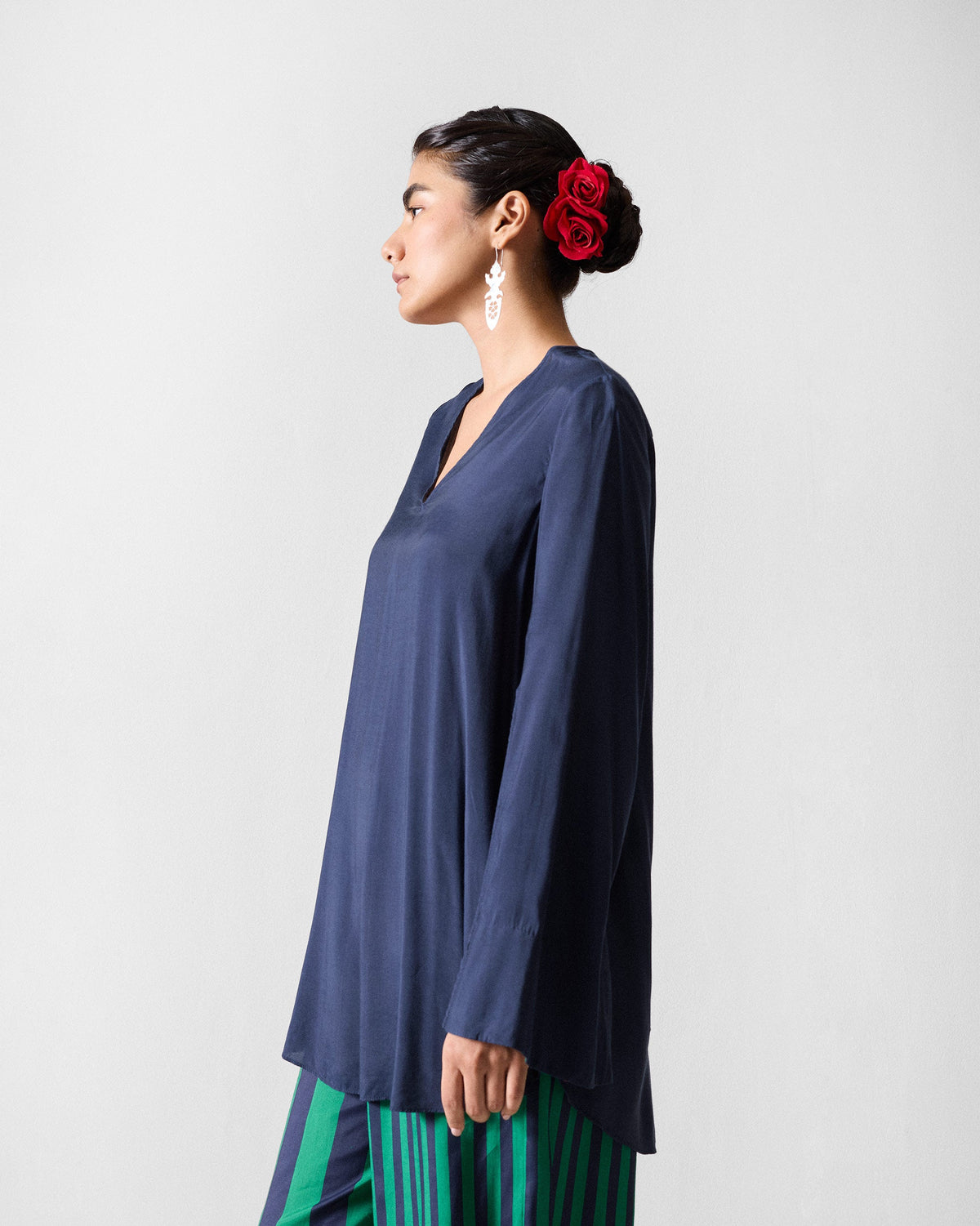 Side view of a navy Panaji set with green and navy striped pants.