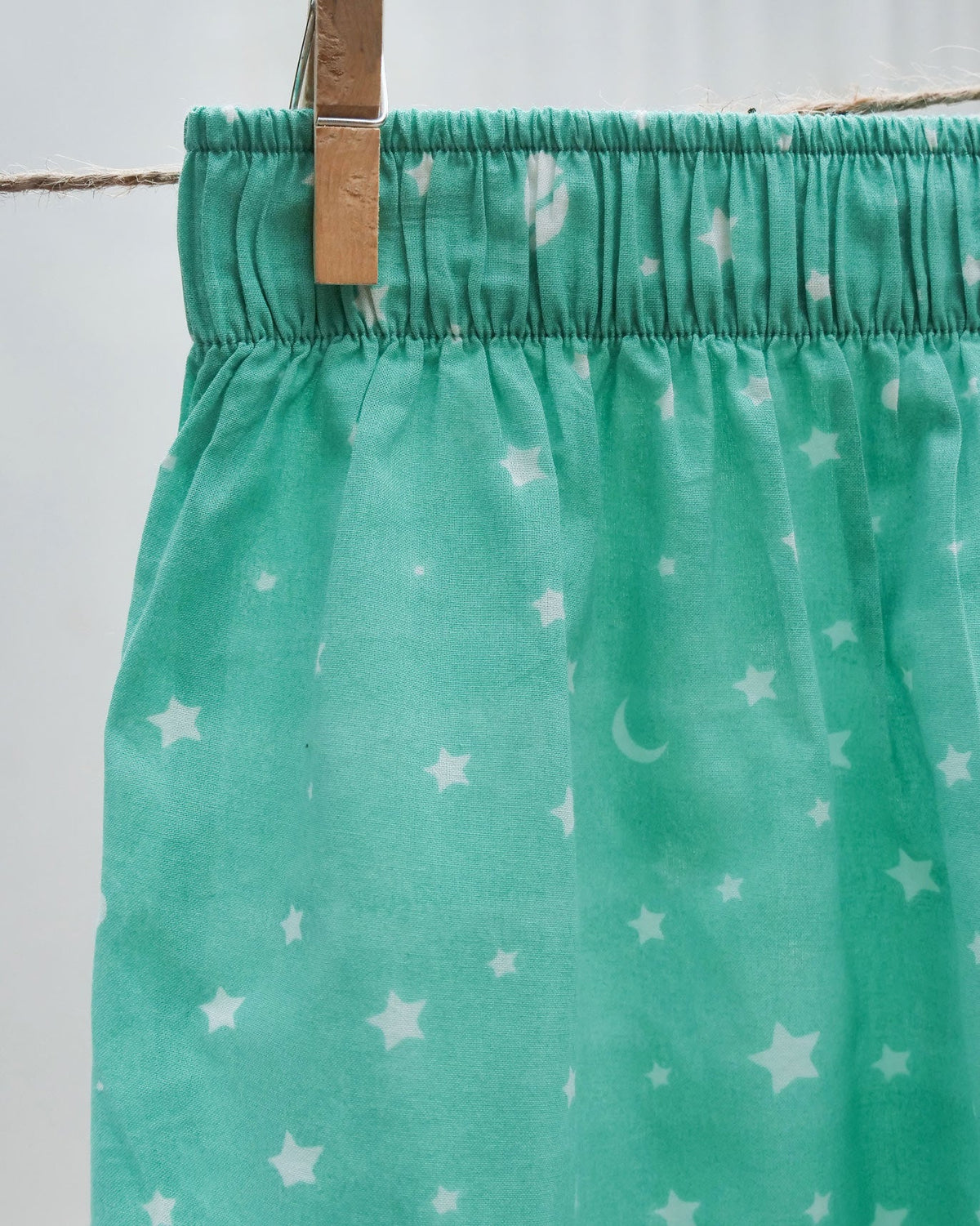 Close-up of the turquoise All The Stars boxers showing the waistband and star print.