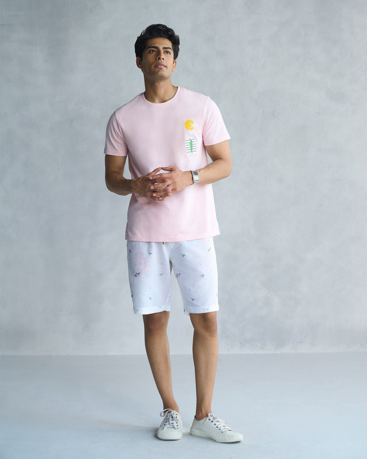 Full-length view of a soft pink See Ya Later Alligator t-shirt worn by a person.