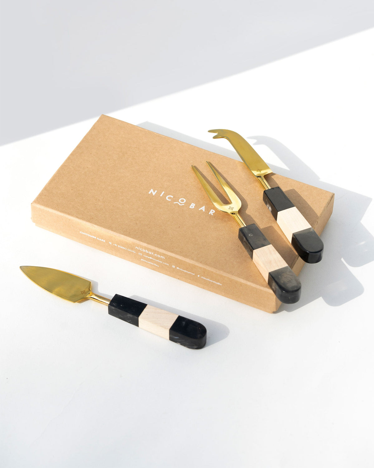 Celeste Cheese Knives (Set of 3) beside their kraft gift box.
