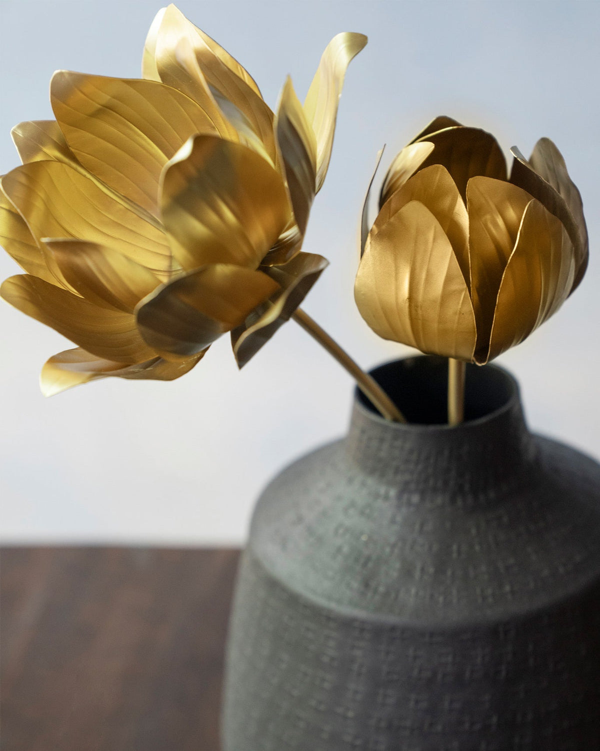 Close-up of Kamal Accent Piece gold metal lotus flowers with layered petals.