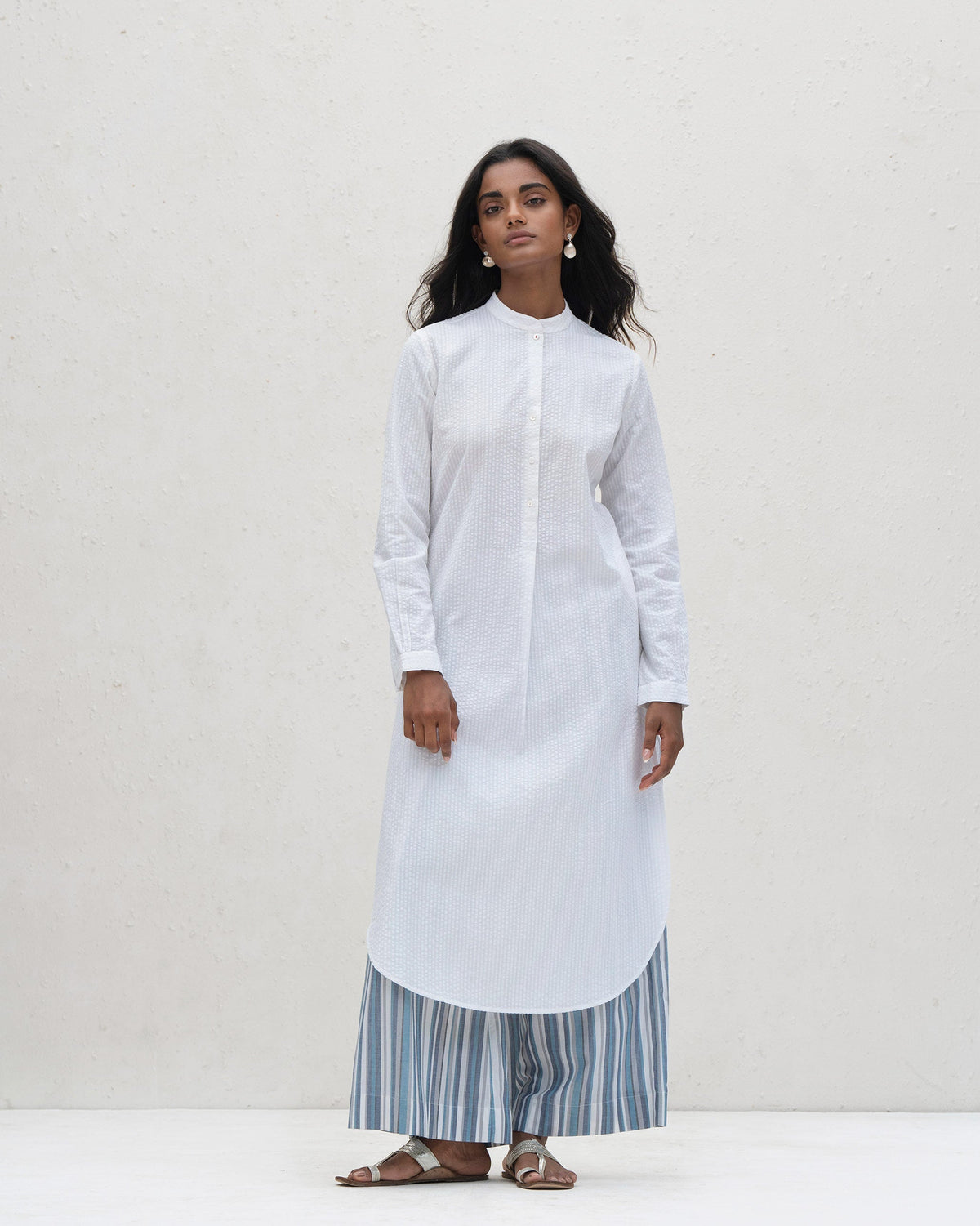 Person wearing a white Basic Long Length Kurta with a buttoned placket.