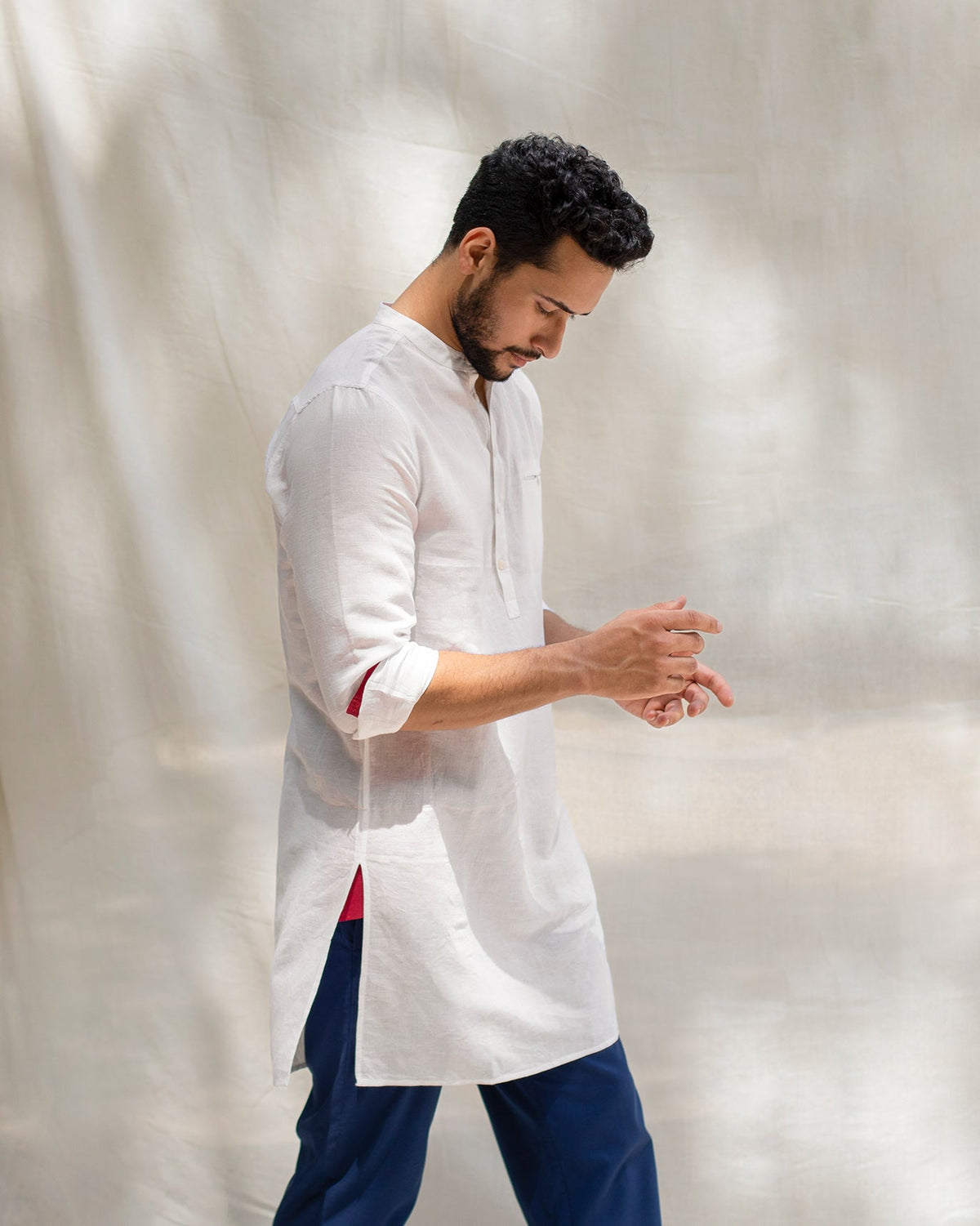 Person in the Pondicherry Kurta in white, with red lining visible at the side slit.
