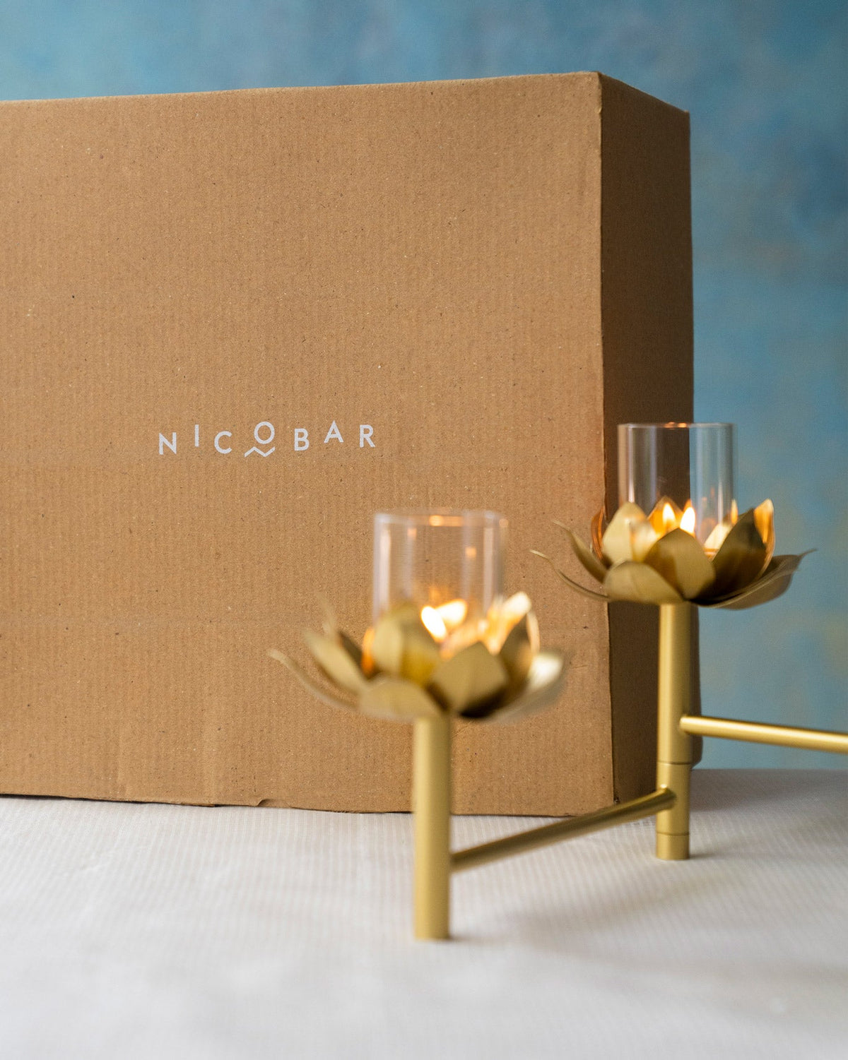 Sitara tealight stand in front of a brown Nicobar box.