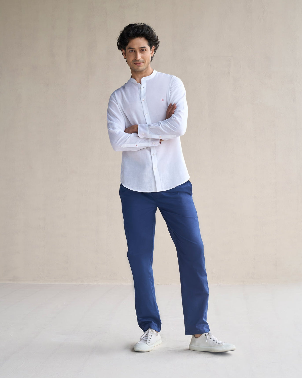 Person wearing a white Nawab shirt, arms crossed, shown head to toe.
