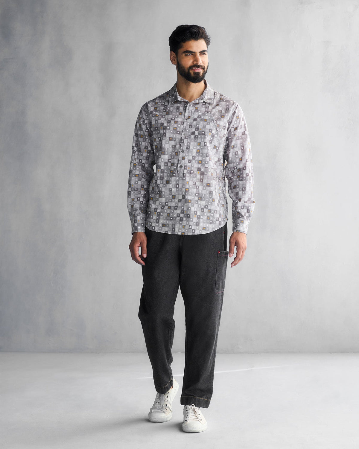 Full-length view of a grey Pocket Shirt with a tile print worn by a person.