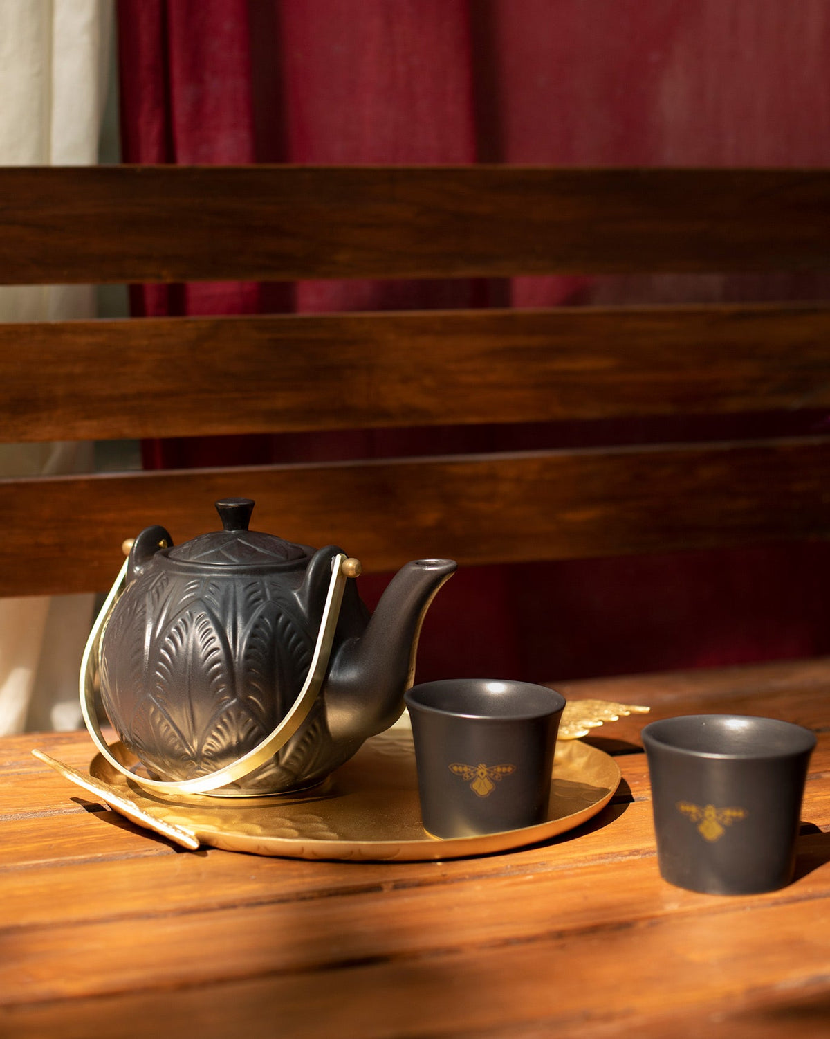 Black Moor teapot and cups on a hammered gold tray.