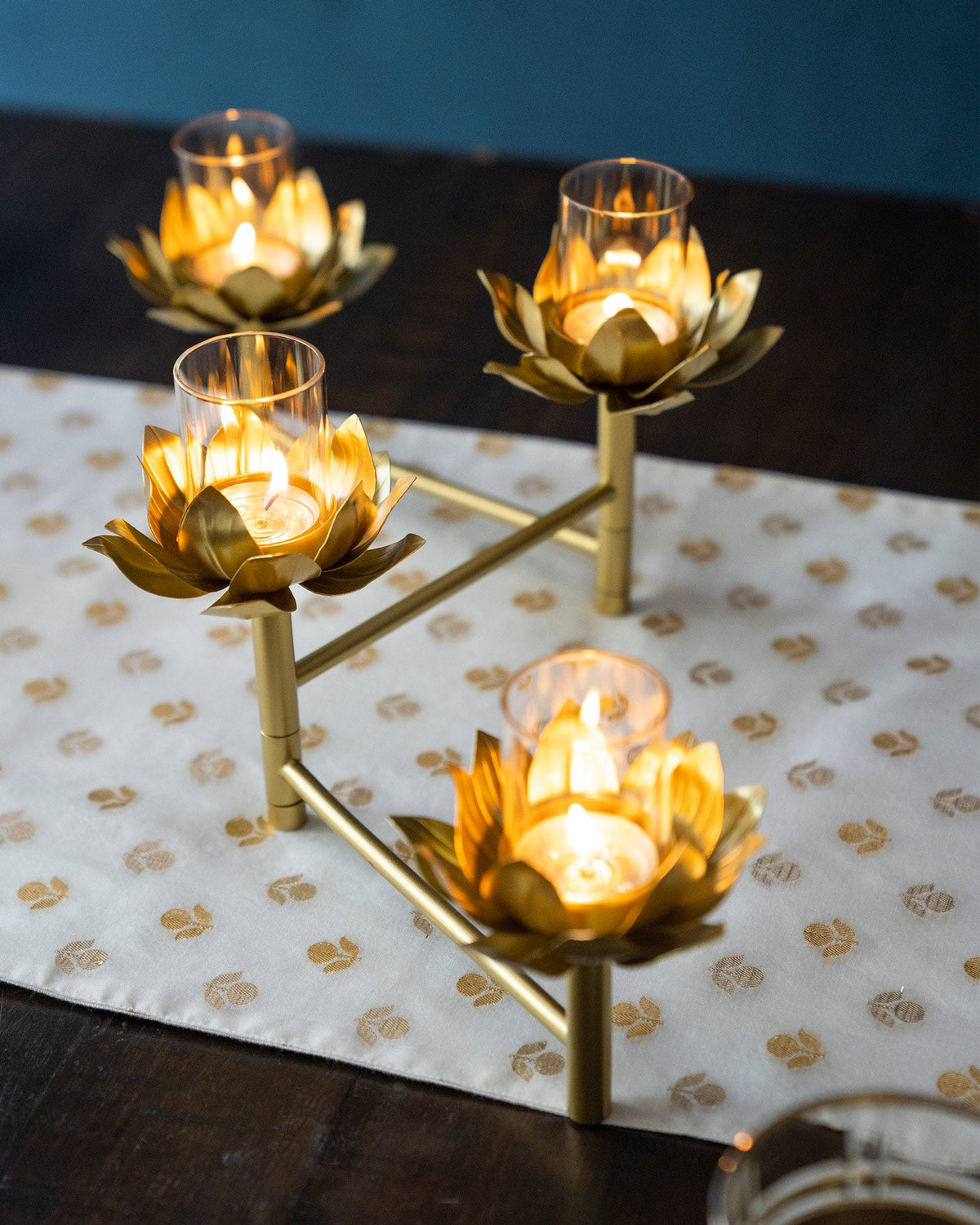Sitara tealight stand with four lit holders, seen from above.
