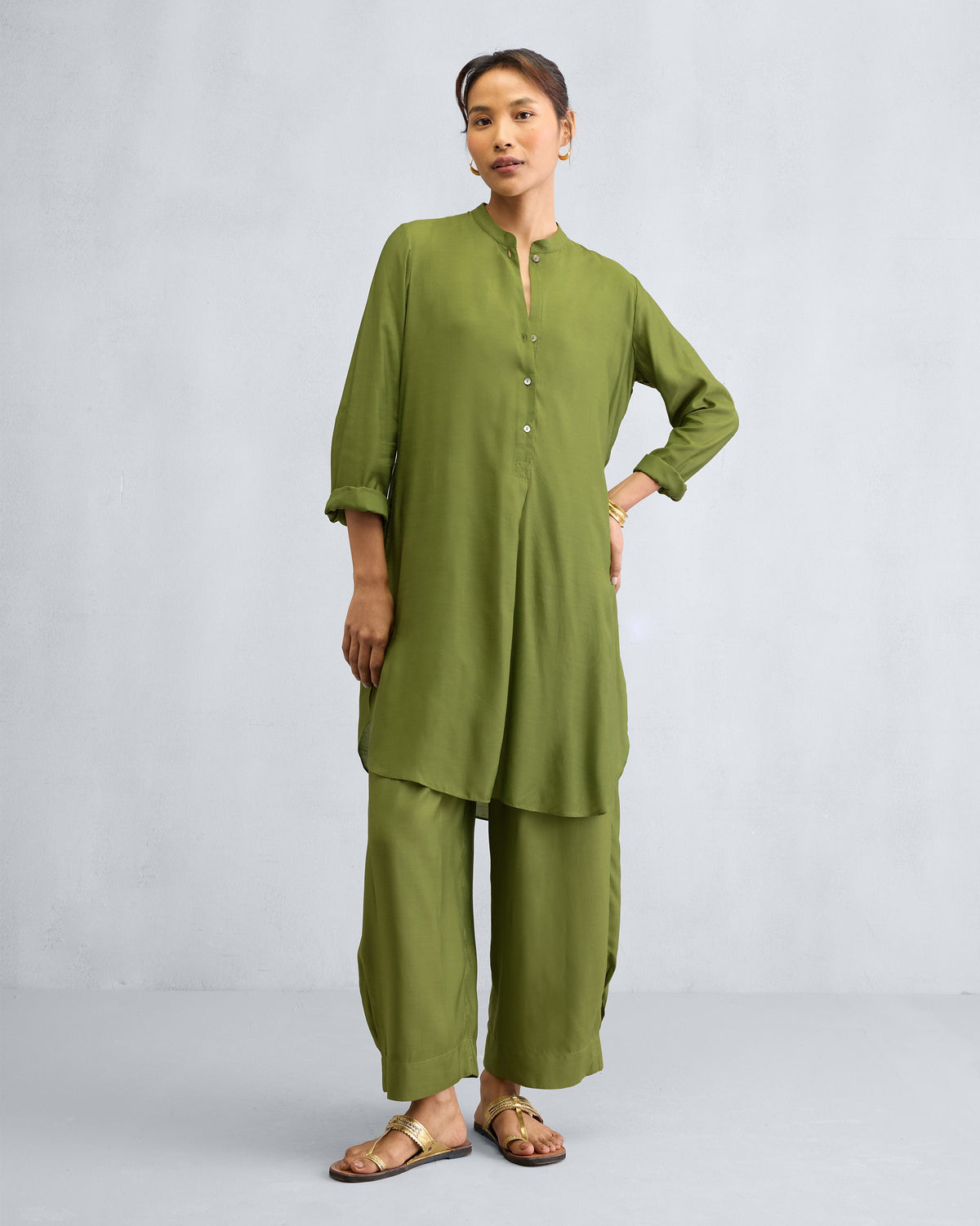 Person wearing an olive mid-length kurta set with matching wide-leg pants.