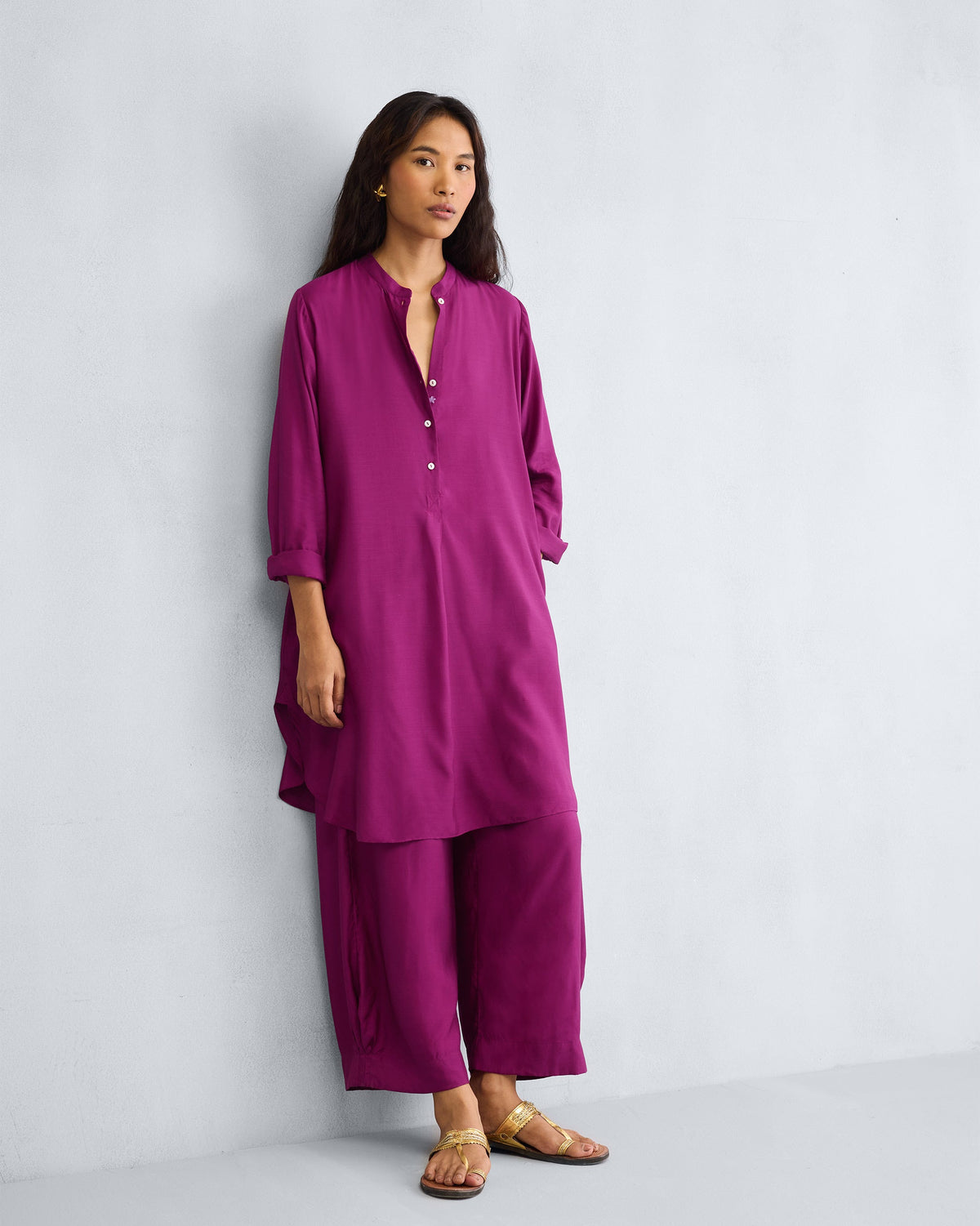 Person wearing a mulberry mid-length kurta set with matching pants.