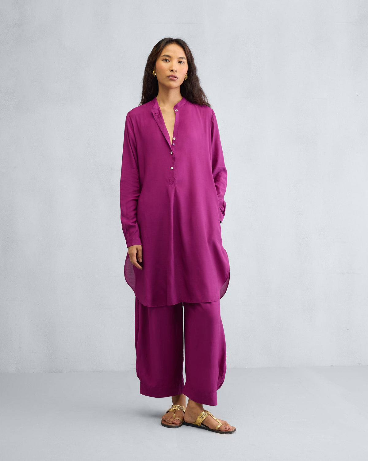 Person wearing a mulberry mid-length kurta set with wide-leg pants.