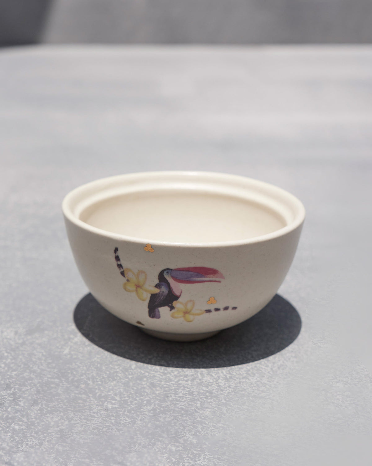 Cream Toucan katori angled to show the toucan motif and open interior.
