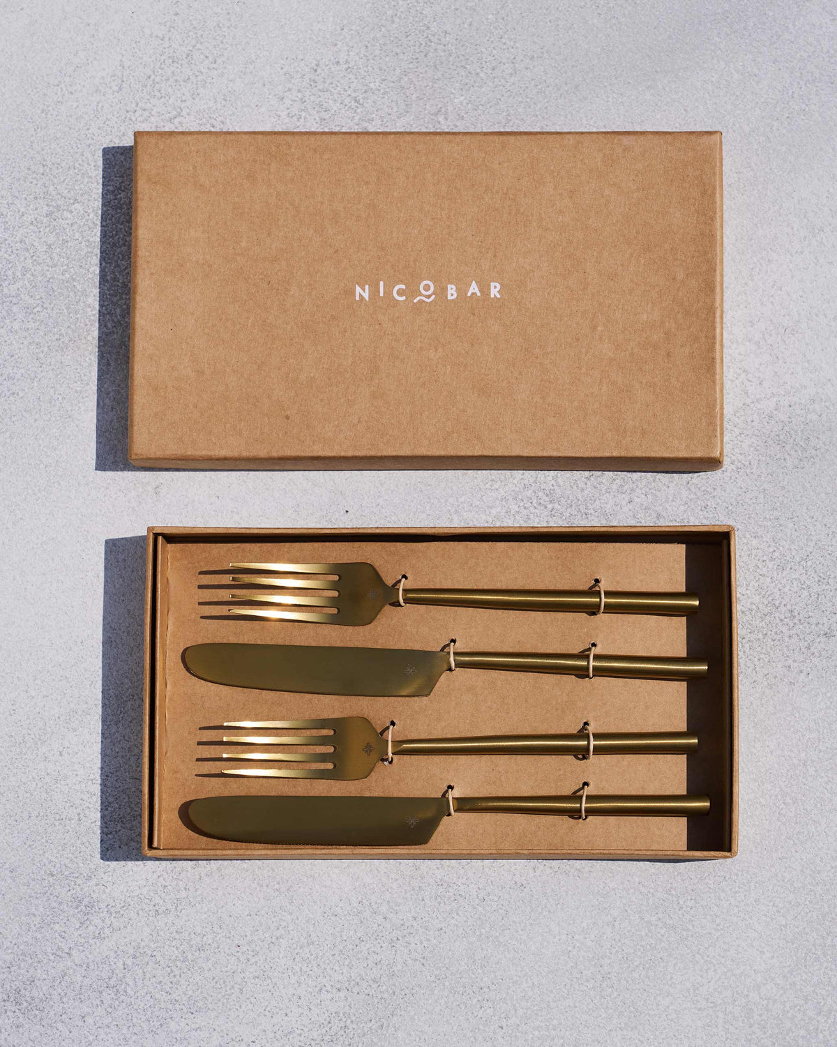 Sitara forks and knives packed in an open Nicobar gift box.