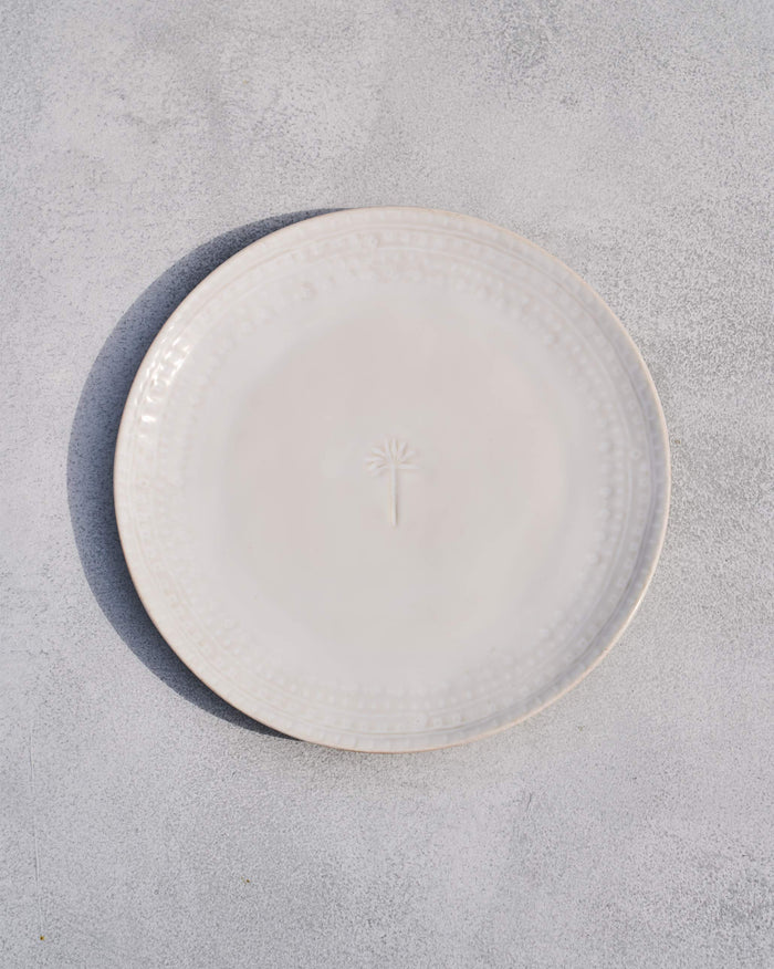 Coco Palm Dinner Plate in white with a small palm motif at the centre.