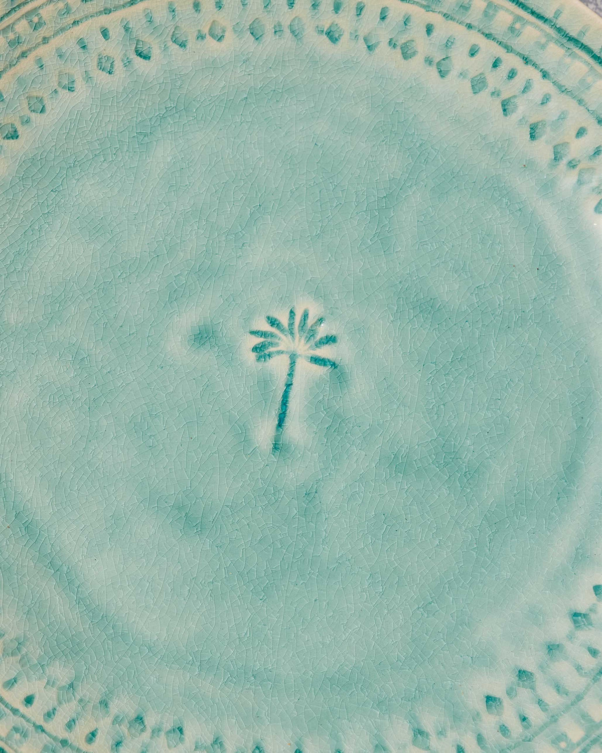 Close-up of the palm motif and crackled aqua glaze on Coco Palm Dinner Plate.