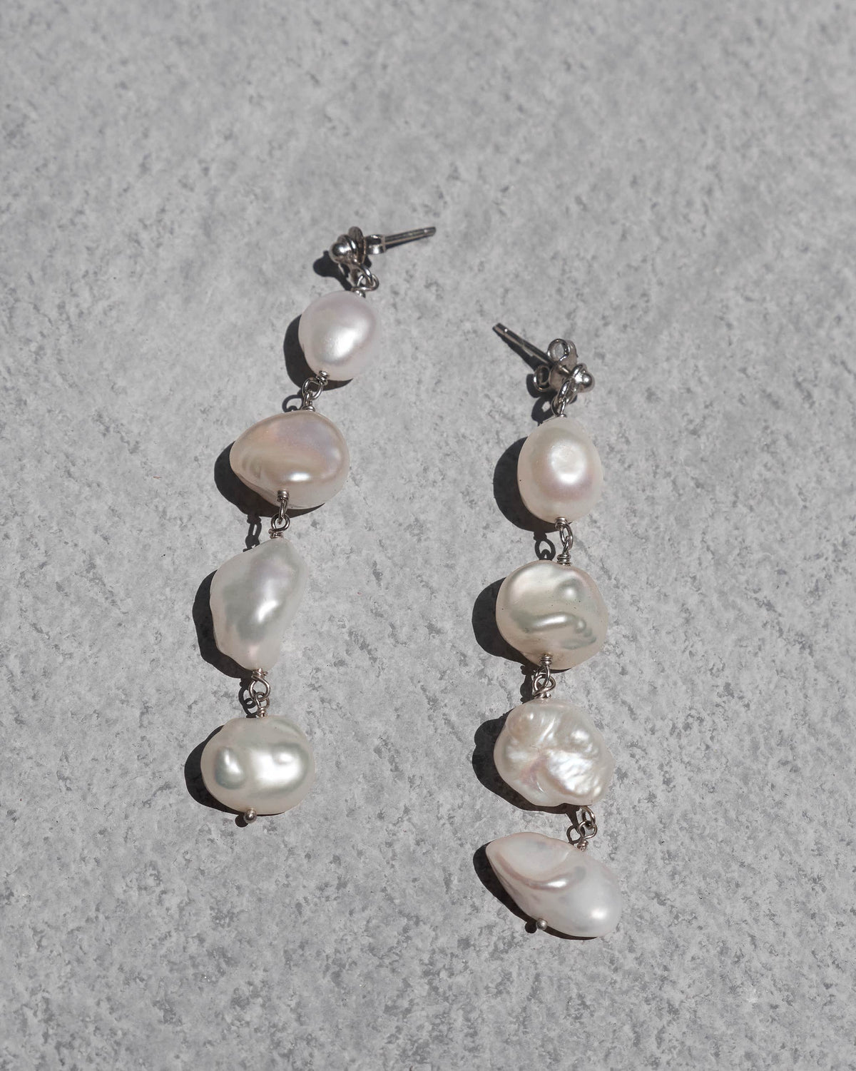 Pair of Tinsel Danglers laid flat showing their pearl drops.