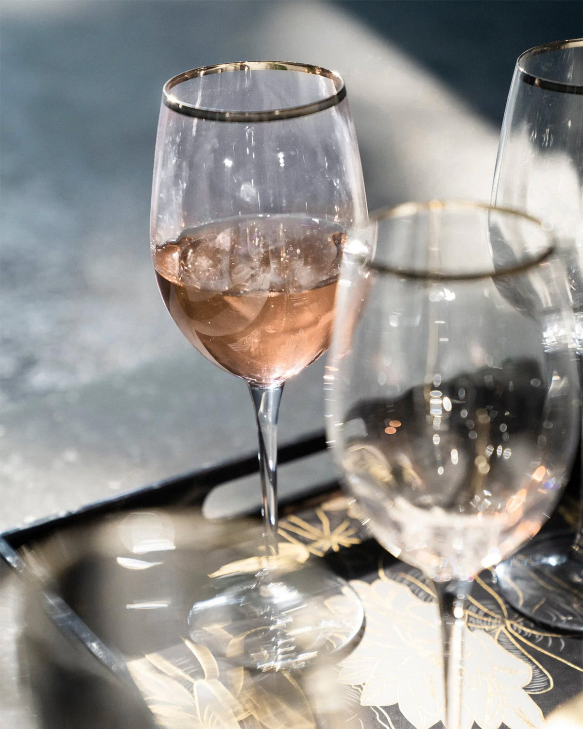 Celeste red wine glass filled with pale pink wine.