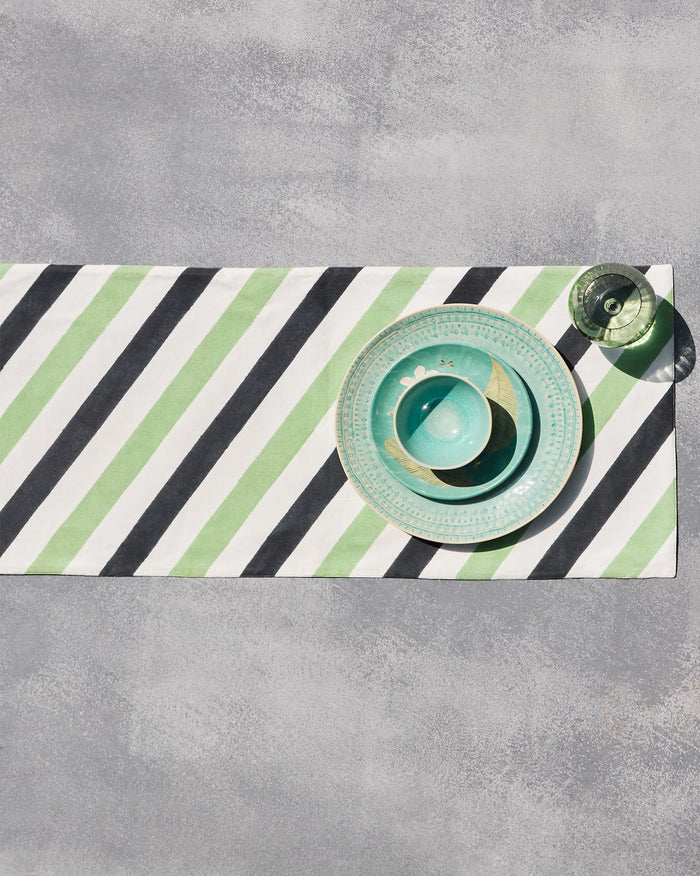 Coast Runner laid flat with diagonal green, black and white stripes.