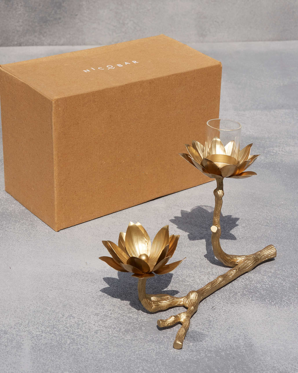 Kamal tea light holder beside its kraft Nicobar gift box.