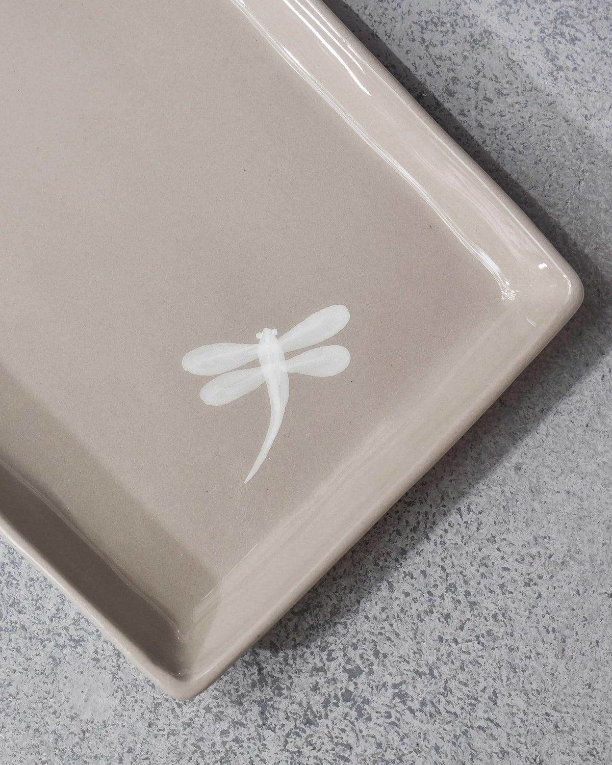Close-up of a white dragonfly motif on the Mandovi Chip & Dip Platter.